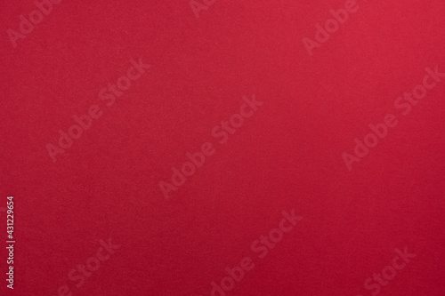 Blank paper sheet of crimson or shade of red color for background with fine texture.