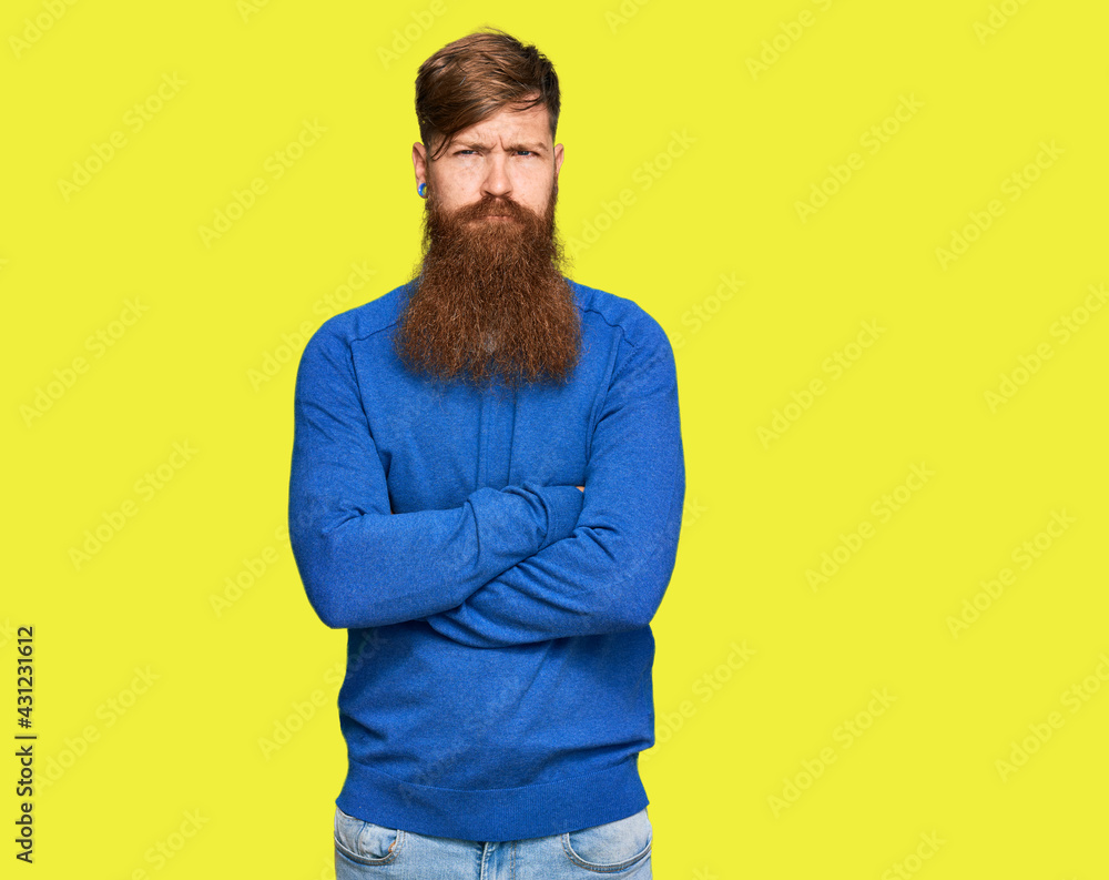 Young irish redhead man wearing casual clothes skeptic and nervous, disapproving expression on face with crossed arms. negative person. Young irish redhead man wearing casual clothes skeptic and nervous, disapproving expression on face with crossed arms. negative person.