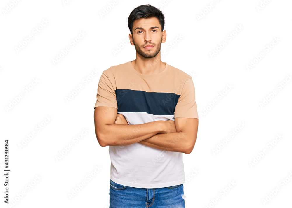 Young handsome man wearing casual clothes skeptic and nervous, disapproving expression on face with crossed arms. negative person. Young handsome man wearing casual clothes skeptic and nervous, disapproving expression on face with crossed arms. negative person.