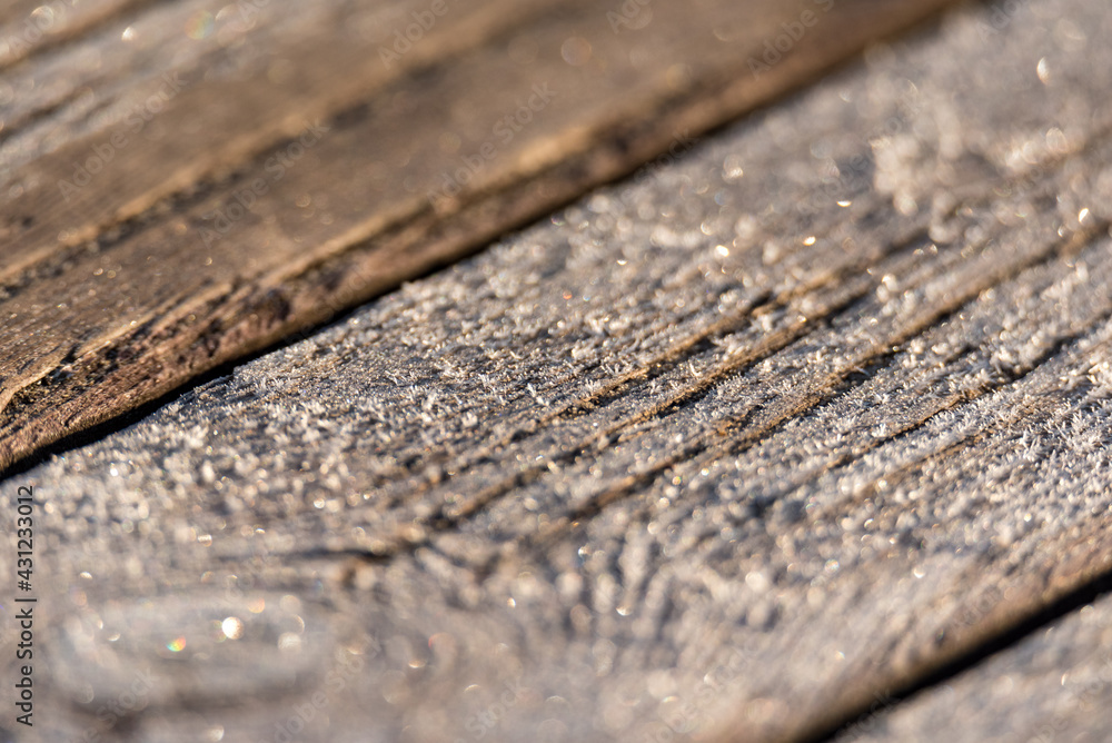 Wooden planks covered with frost, background. Temperature change with high humidity. Spring changeable weather.