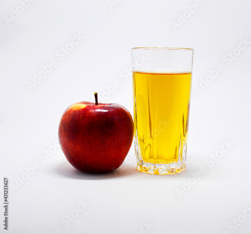 ripe red apple and glass glass of apple juice on white background