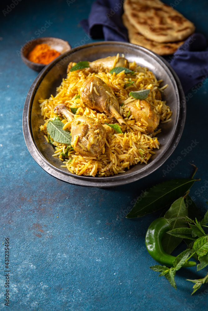 Chiken biryani Rice with yogur and mint on metal, top view. Pakistani and indian dish