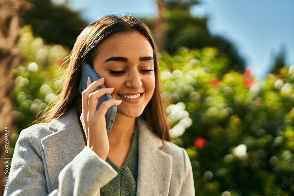 Young hispanic girl smiling happy talking on the smartphone at the city. Young hispanic girl smiling happy talking on the smartphone at the city.