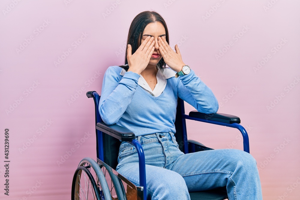 Beautiful woman with blue eyes sitting on wheelchair rubbing eyes for fatigue and headache, sleepy and tired expression. vision problem Beautiful woman with blue eyes sitting on wheelchair rubbing eyes for fatigue and headache, sleepy and tired expression. vision problem