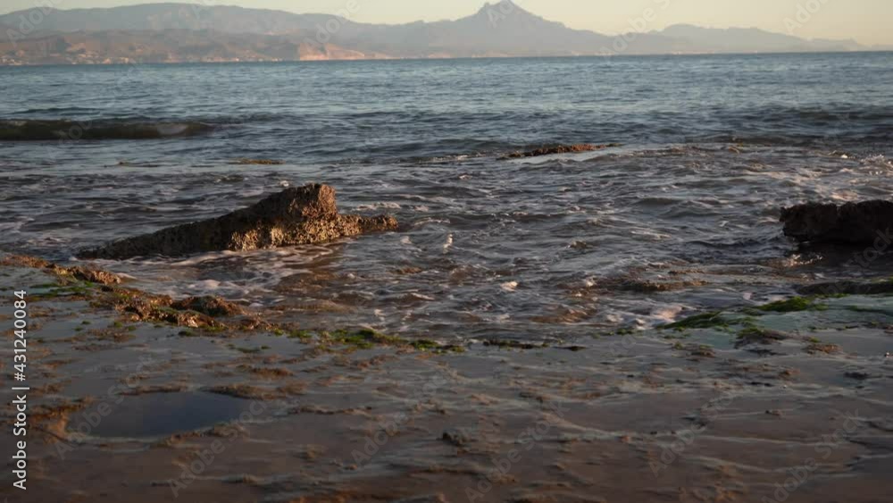 beautiful sunrise in the sea with the movement of the waves on the beach of Cabo Huertas in Alicante, located in the Valencina community, Spain beautiful sunrise in the sea with the movement of the waves on the beach of Cabo Huertas in Alicante, located in the Valencina community, Spain