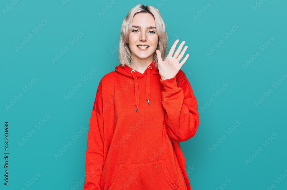 Young blonde girl wearing casual clothes showing and pointing up with fingers number five while smiling confident and happy. Young blonde girl wearing casual clothes showing and pointing up with fingers number five while smiling confident and happy.