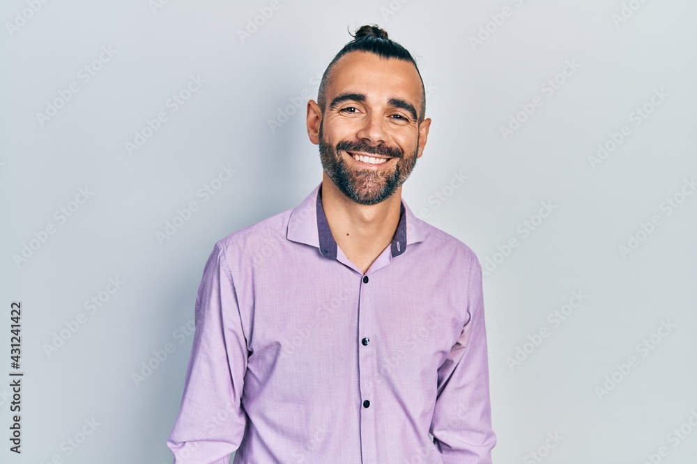 Young hispanic man wearing casual clothes with a happy and cool smile on face. lucky person. Young hispanic man wearing casual clothes with a happy and cool smile on face. lucky person.