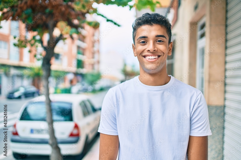 Young latin man smiling happy walking at the city. Young latin man smiling happy walking at the city.