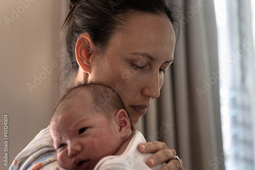 Canvas Print A stressed tired mother trying to put her baby to sleep