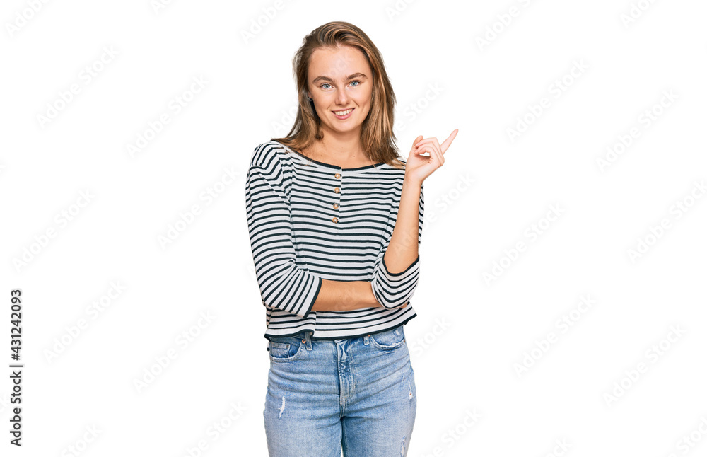 Beautiful blonde woman wearing casual clothes with a big smile on face, pointing with hand and finger to the side looking at the camera. Beautiful blonde woman wearing casual clothes with a big smile on face, pointing with hand and finger to the side looking at the camera.