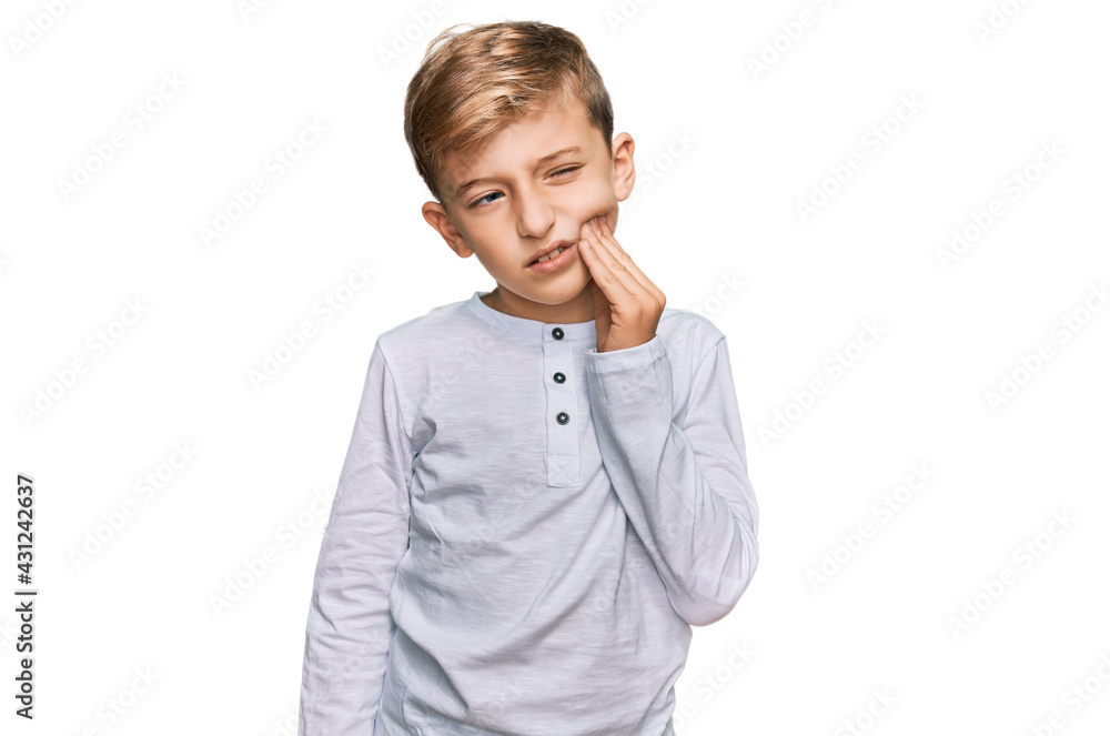 Little caucasian boy kid wearing casual clothes touching mouth with hand with painful expression because of toothache or dental illness on teeth. dentist Little caucasian boy kid wearing casual clothes touching mouth with hand with painful expression because of toothache or dental illness on teeth. dentist