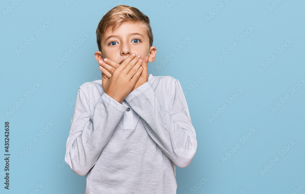 Little caucasian boy kid wearing casual clothes shocked covering mouth with hands for mistake. secret concept. Little caucasian boy kid wearing casual clothes shocked covering mouth with hands for mistake. secret concept.