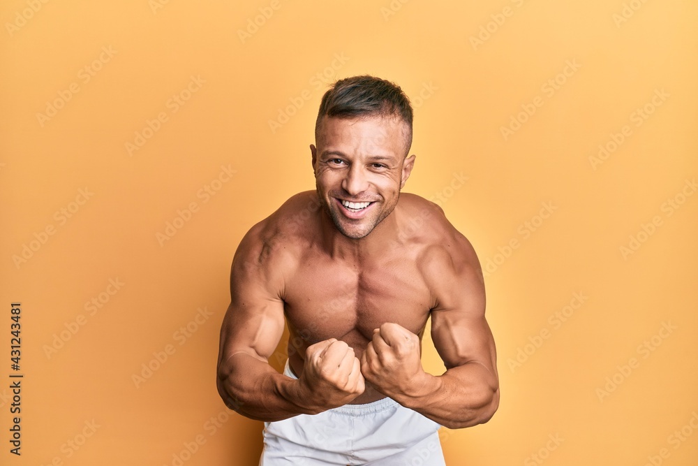 Handsome bodybuldier man posing sexy showing muscle, shirtless torso showing pectorals and sixpack