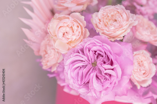 Light pink, purple, peach colour, white cute delicate small roses of different sizes, flowers in a lush bouquet. Close-up. Place for text