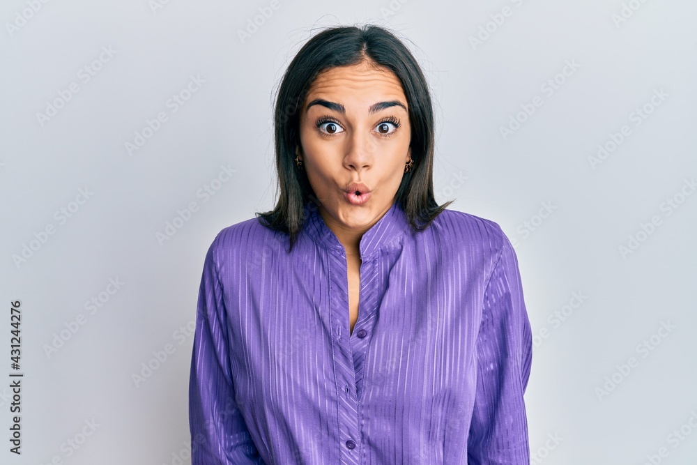 Fototapeta premium Young brunette woman wearing casual clothes afraid and shocked with surprise expression, fear and excited face.