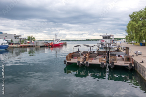 Photography Looking from the Spadian Wave Deck over parked water taxis and the Toronto Fire Marine unit to the Toronto Islands