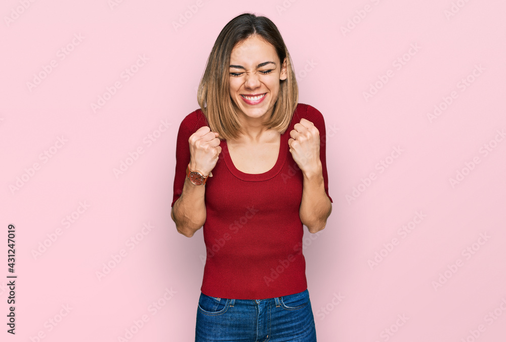 Young blonde girl wearing casual clothes excited for success with arms raised and eyes closed celebrating victory smiling. winner concept. Young blonde girl wearing casual clothes excited for success with arms raised and eyes closed celebrating victory smiling. winner concept.