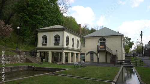 Motion to left showing Berkeley Springs State Park historic museum and bath house in West Virginia in the Appalachia mountains. photo