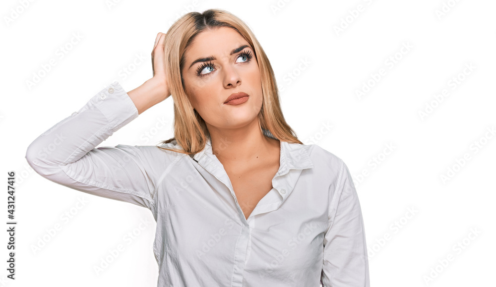 Young caucasian woman wearing casual clothes confuse and wondering about question. uncertain with doubt, thinking with hand on head. pensive concept. Young caucasian woman wearing casual clothes confuse and wondering about question. uncertain with doubt, thinking with hand on head. pensive concept.