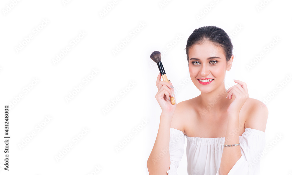 Skin care cosmetic concept. Beautiful young woman holding blusher in own hand applying powder makeup face while sitting over isolated white background. Skin care cosmetic concept. Beautiful young woman holding blusher in own hand applying powder makeup face while sitting over isolated white background.