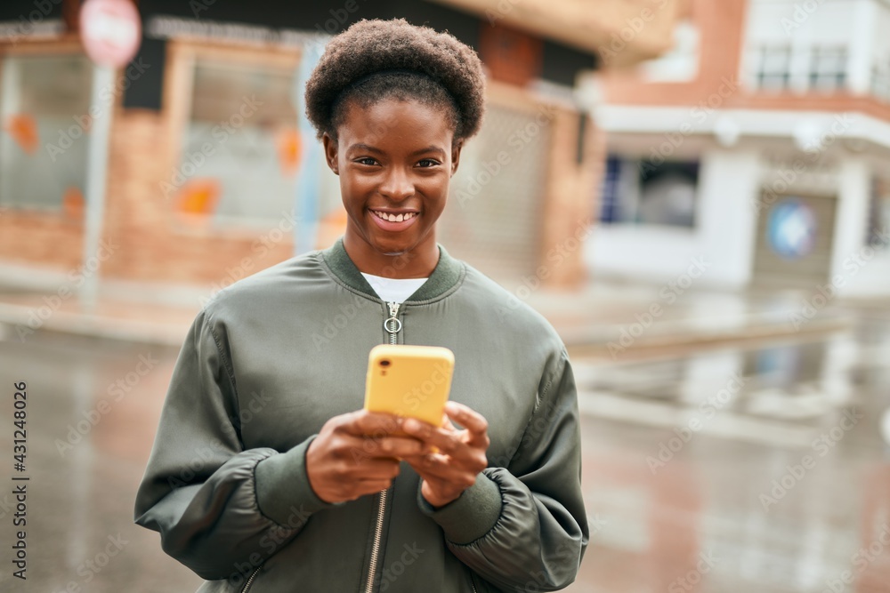 Young african american girl smiling happy using smartphone at the city Young african american girl smiling happy using smartphone at the city