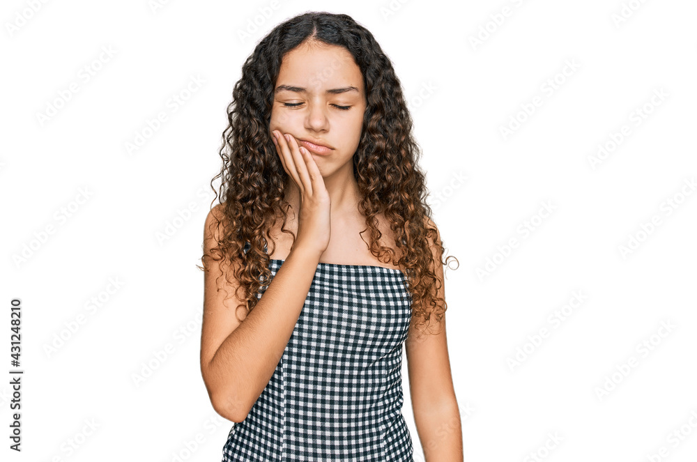 Teenager hispanic girl wearing casual clothes touching mouth with hand with painful expression because of toothache or dental illness on teeth. dentist Teenager hispanic girl wearing casual clothes touching mouth with hand with painful expression because of toothache or dental illness on teeth. dentist