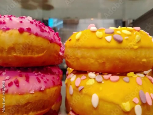 Moving along a bakery shop window with color mixed doughnut