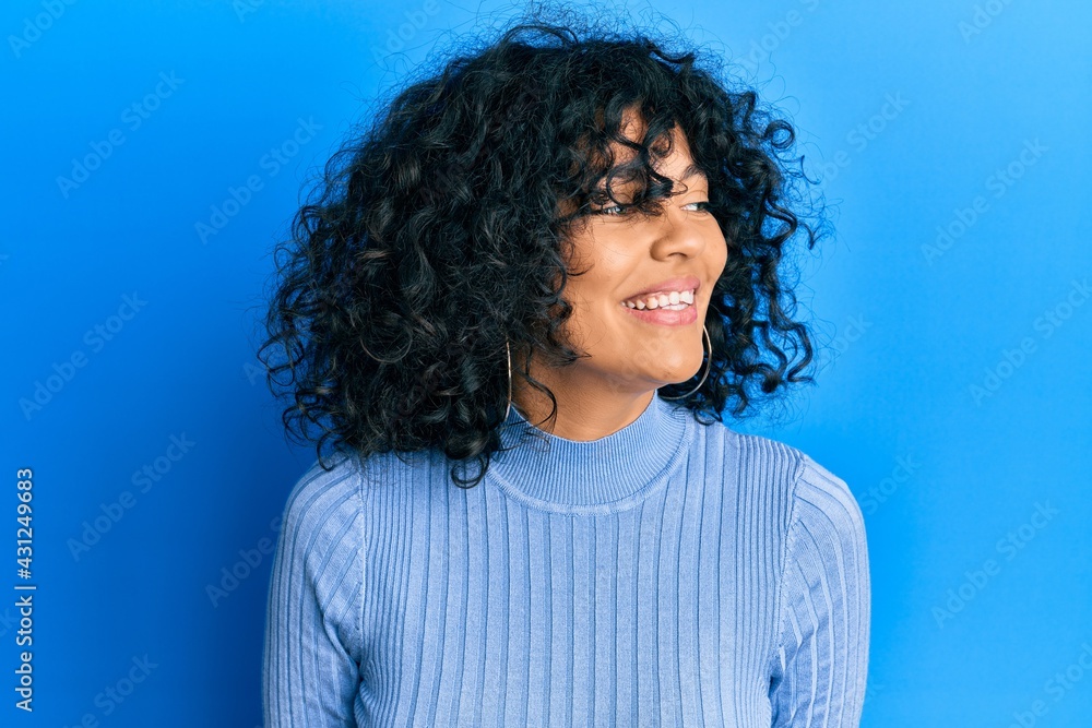 Fototapeta premium Young hispanic woman wearing casual clothes looking to side, relax profile pose with natural face and confident smile.