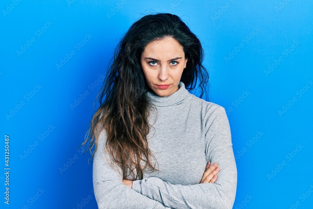 Obraz premium Young hispanic woman wearing casual clothes skeptic and nervous, disapproving expression on face with crossed arms. negative person.