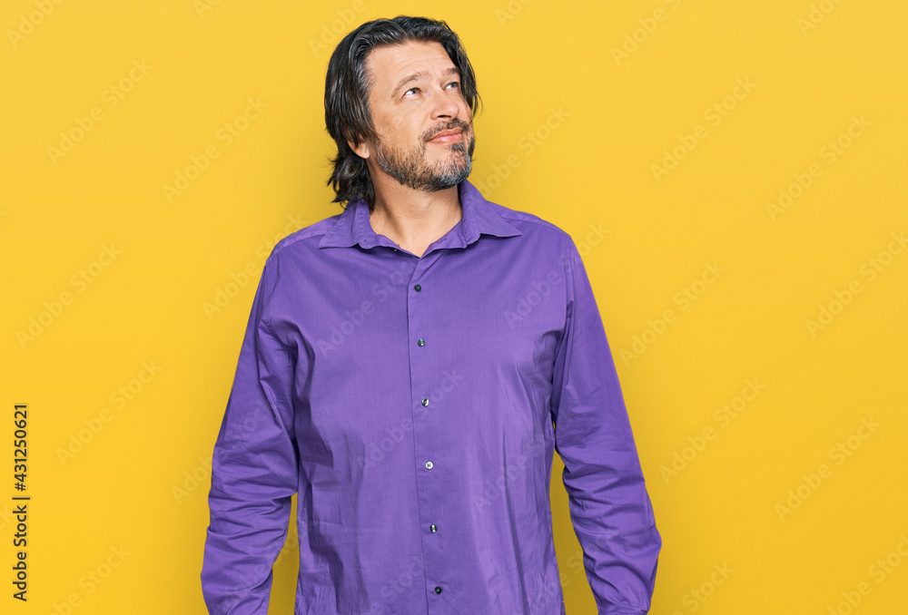 Fototapeta premium Middle age handsome man wearing business shirt looking away to side with smile on face, natural expression. laughing confident.