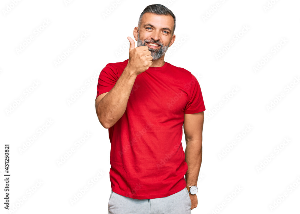Middle age handsome man wearing casual clothes doing happy thumbs up gesture with hand. approving expression looking at the camera showing success. Middle age handsome man wearing casual clothes doing happy thumbs up gesture with hand. approving expression looking at the camera showing success.