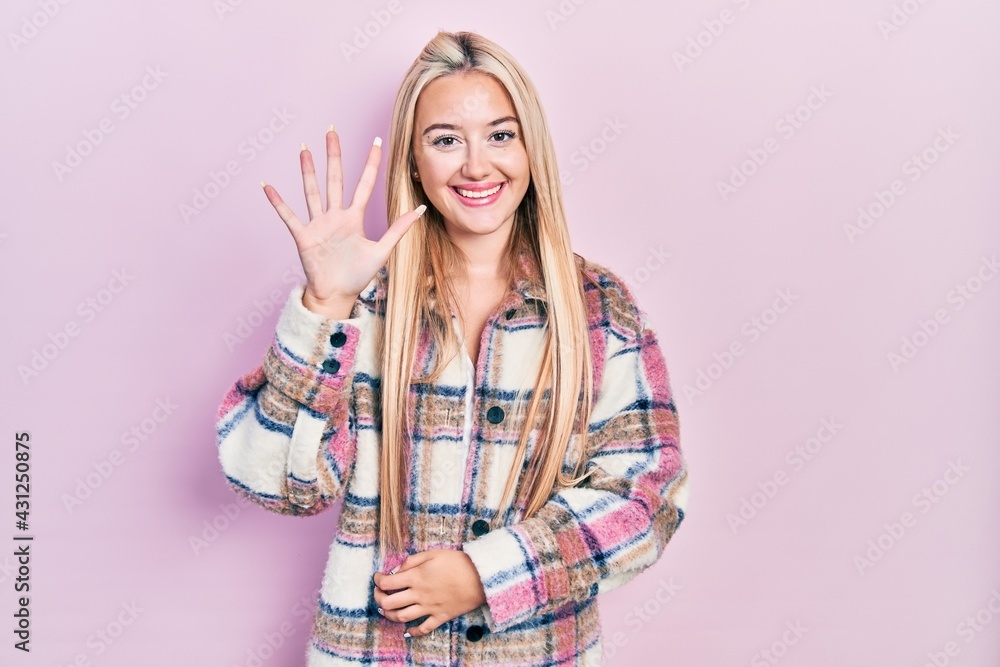 Young blonde girl wearing casual clothes showing and pointing up with fingers number five while smiling confident and happy. Young blonde girl wearing casual clothes showing and pointing up with fingers number five while smiling confident and happy.