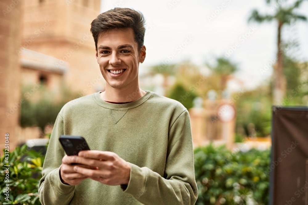 © Krakenimages.com - Young hispanic man smiling happy using smartphone at the city. © Krakenimages.com - Young hispanic man smiling happy using smartphone at the city.