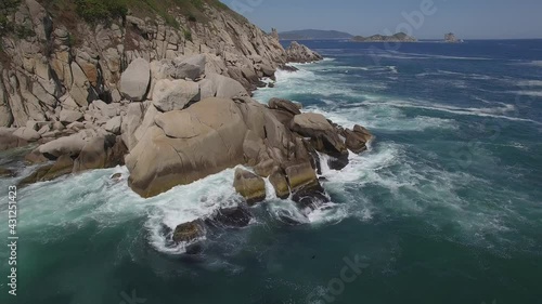 View from a droneon a stone cape washed by strong waves photo