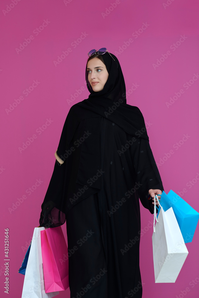 Happy muslim girl posing with shopping bags