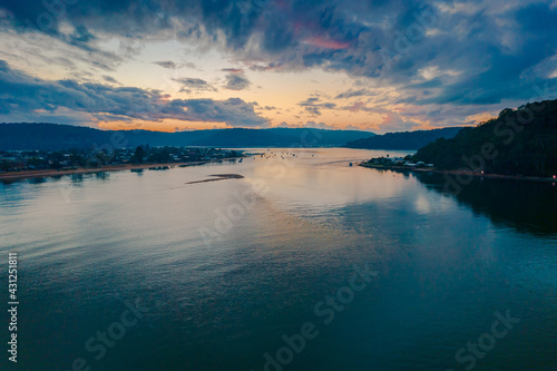 Aerial sunrise waterscape with boats and cloud cover