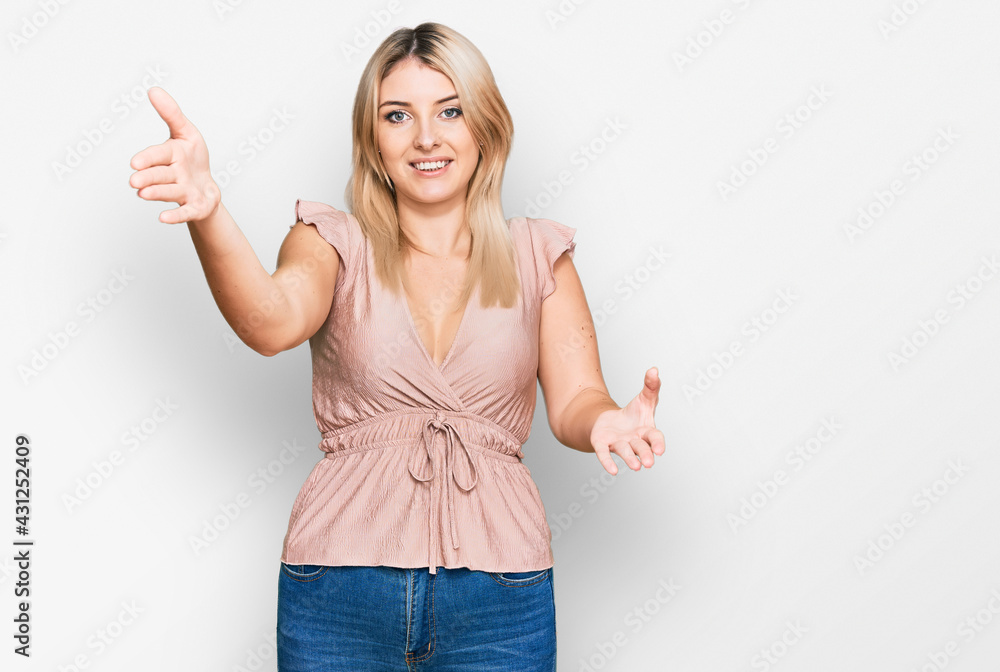 Young caucasian woman wearing casual clothes looking at the camera smiling with open arms for hug. cheerful expression embracing happiness. Young caucasian woman wearing casual clothes looking at the camera smiling with open arms for hug. cheerful expression embracing happiness.
