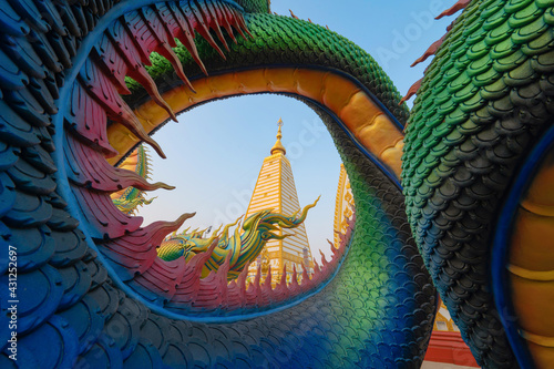 Serpent statue sculpture of chedi stupa pagoda Buddhism in Wat Phra That Nong Bua Dhammyuttika temple, Ubon Ratchathani district, Thailand. photo