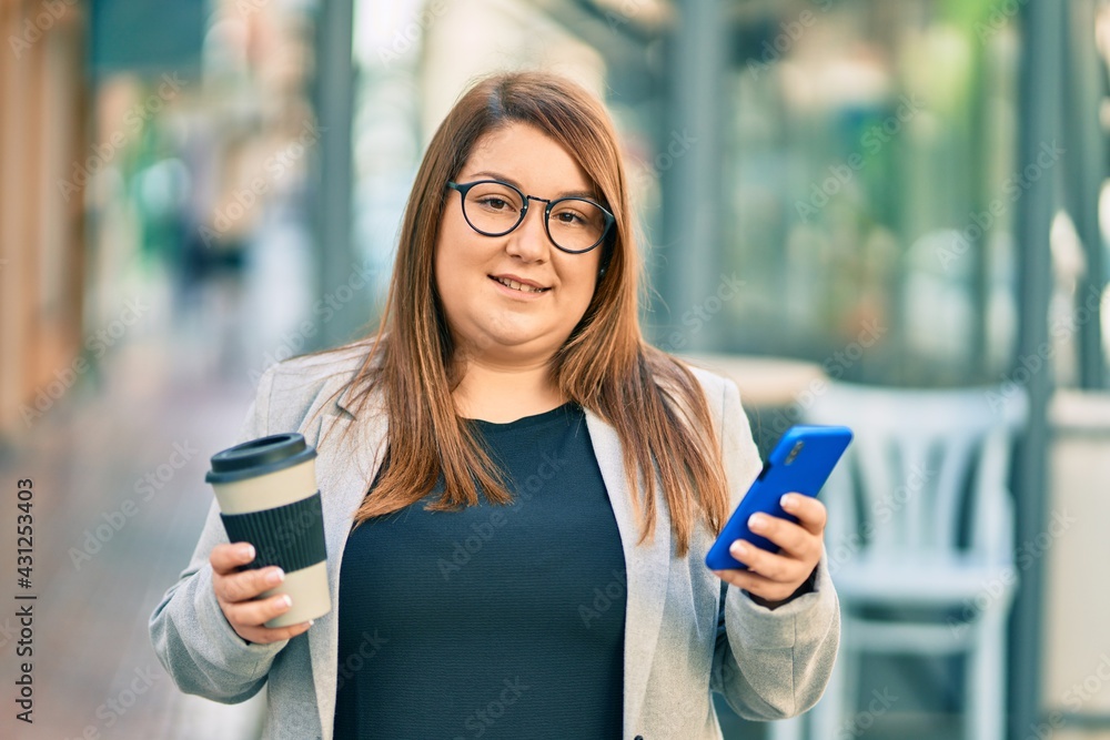 Young plus size businesswoman using smartphone and drinking coffee at the city.