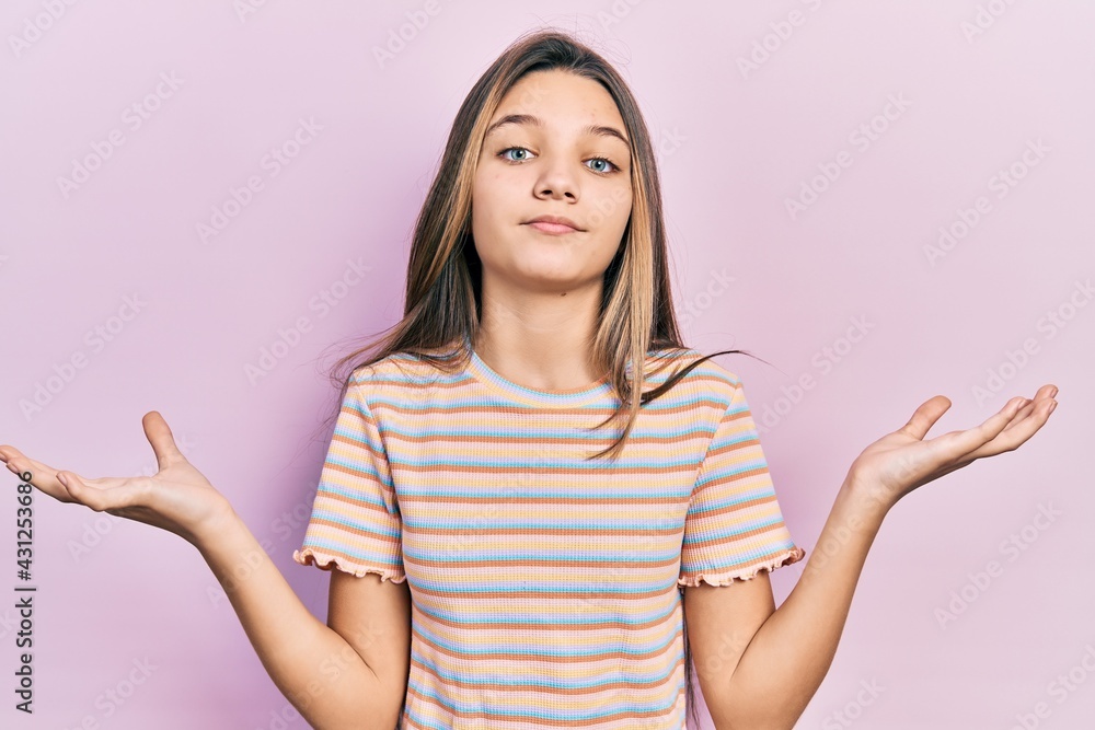 Young brunette girl wearing casual striped t shirt clueless and confused with open arms, no idea and doubtful face. Young brunette girl wearing casual striped t shirt clueless and confused with open arms, no idea and doubtful face.