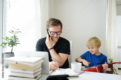 Quadro em tela Father freelancer working from home with laptop during quarantine
