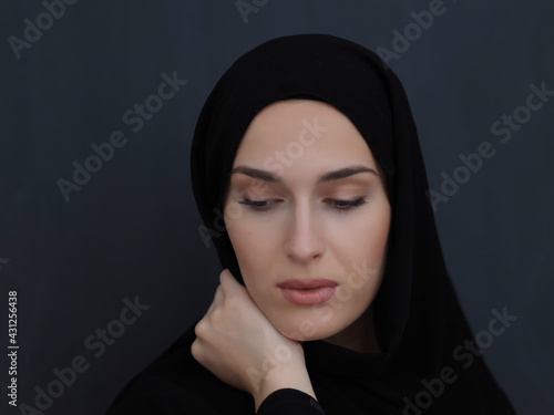 Portrait of modern young muslim woman in black abaya