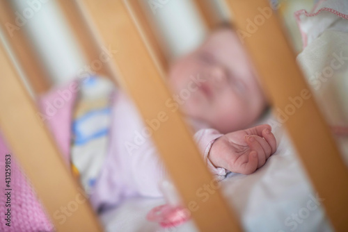 newborn baby sleeping at home in bed