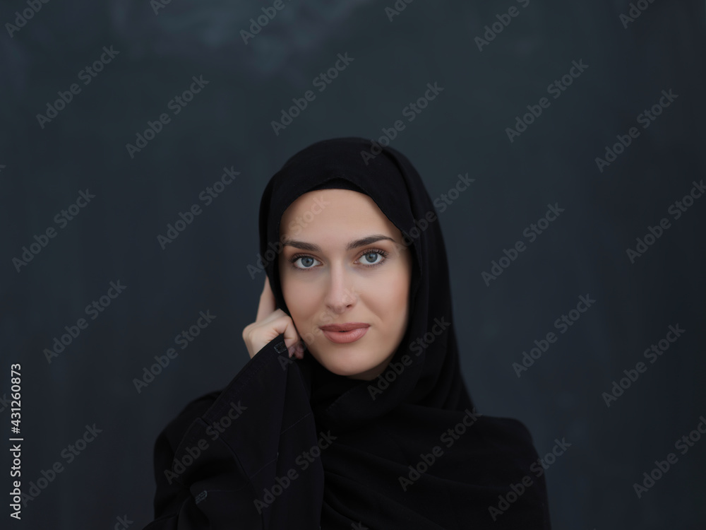 Young muslim businesswoman in traditional clothes or abaya talking on the smartphone Young muslim businesswoman in traditional clothes or abaya talking on the smartphone