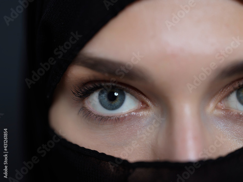 Portrait of muslim woman wearing niqab and traditional arabic clothes or abaya