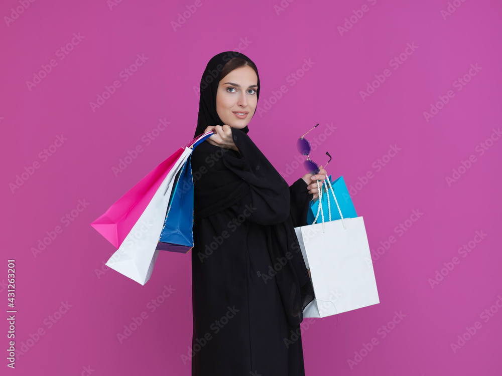 Happy Muslim woman posing with shopping bags