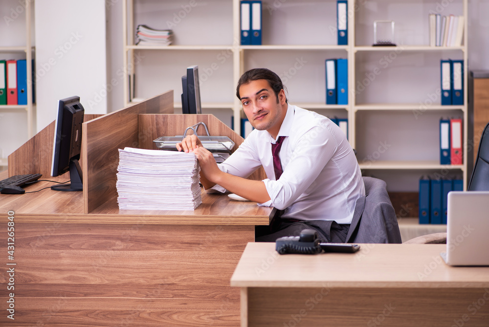 Young male employee extremely tired with excessive work Young male employee extremely tired with excessive work