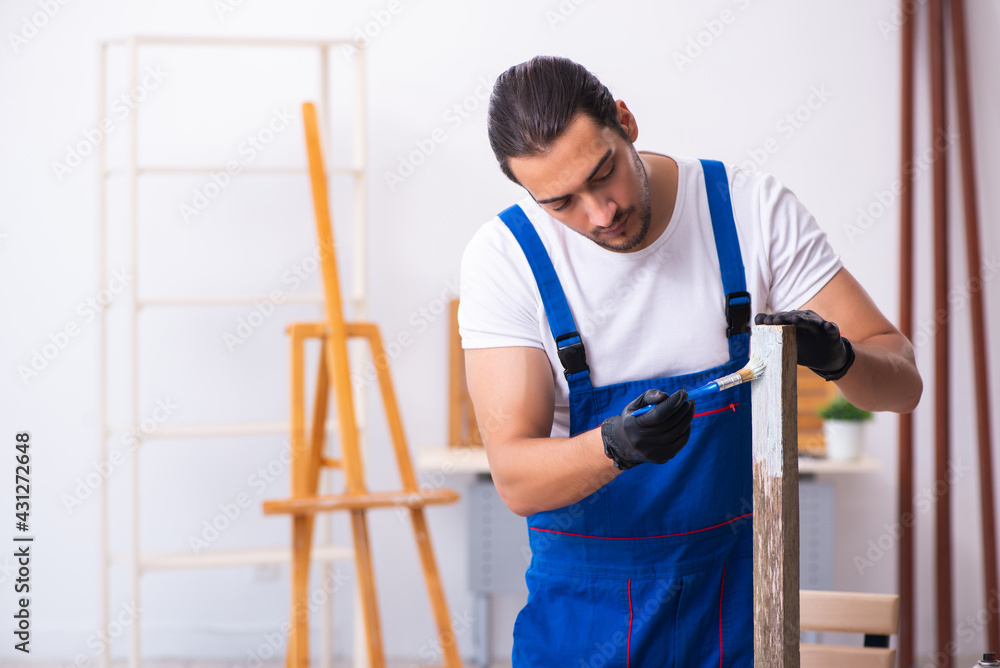 Young male contractor working in workshop Young male contractor working in workshop