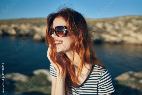 happy traveler wearing sunglasses on vacation in the mountains in nature © SHOTPRIME STUDIO