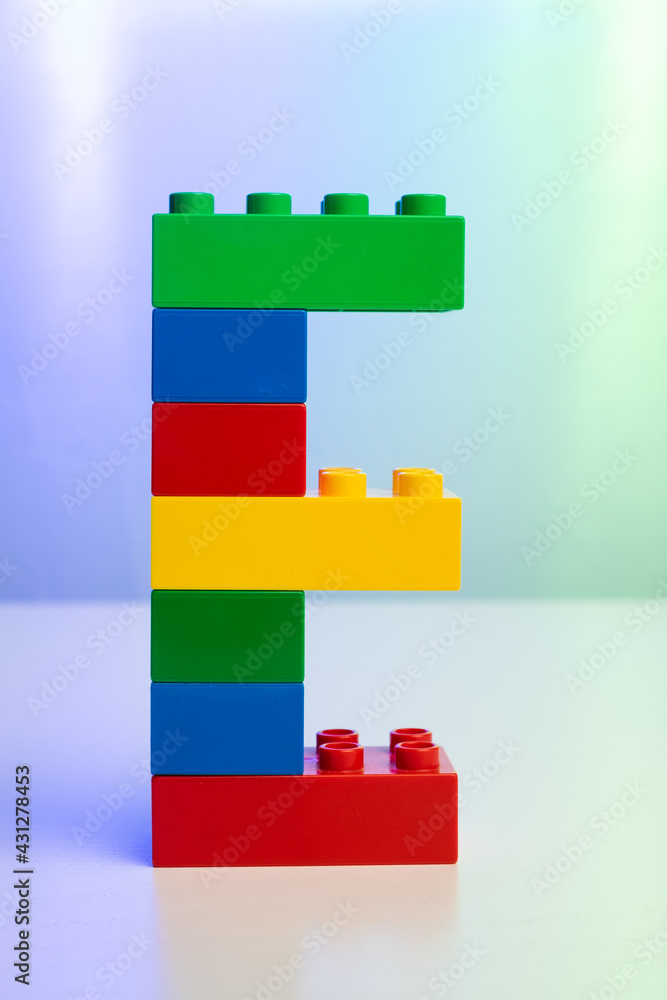 Fototapeta premium the letter E built from toy brick letters 